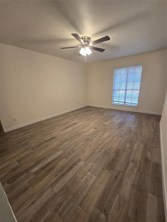 1012 Lynn Street, Unit A Weatherford, TX 76086 - Photo 3 of 15 a view of a room with wooden floor and a ceiling fan