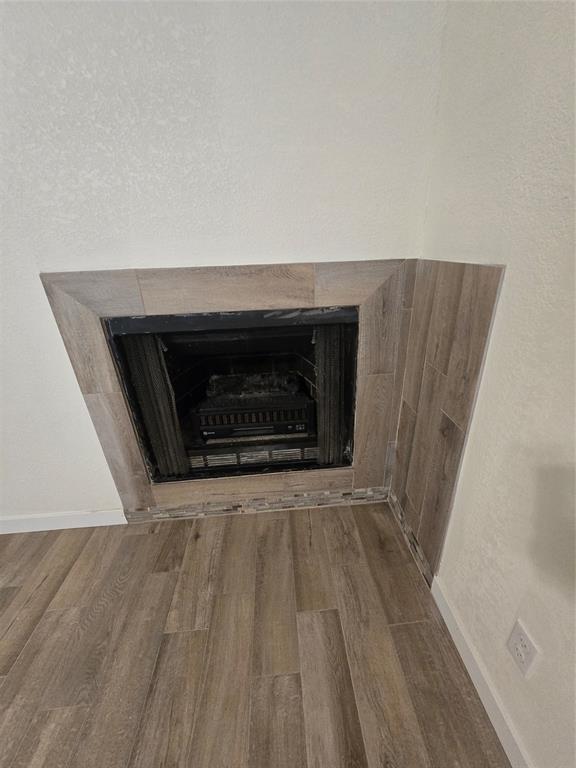 1012 Lynn Street, Unit A Weatherford, TX 76086 - Photo 4 of 15 a view of empty room with wooden floor and fireplace