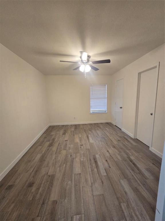 1012 Lynn Street, Unit A Weatherford, TX 76086 - Photo 5 of 15 a view of empty room with wooden floor and fan