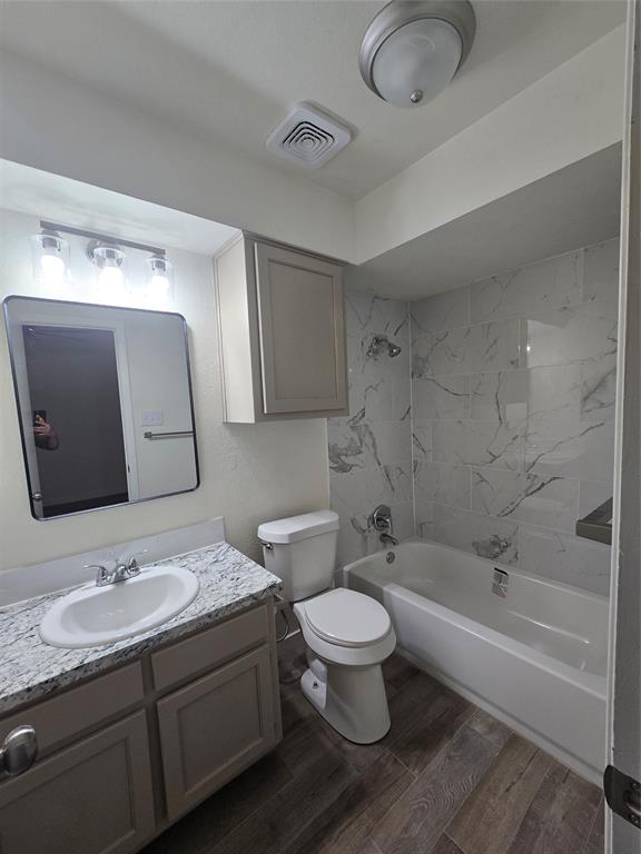 1012 Lynn Street, Unit A Weatherford, TX 76086 - Photo 6 of 15 a bathroom with a granite countertop sink mirror vanity and toilet