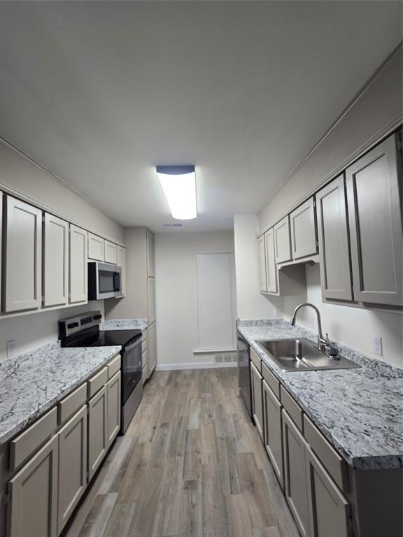 1012 Lynn Street, Unit A Weatherford, TX 76086 - Photo 8 of 15 a kitchen with granite countertop a sink stove and refrigerator