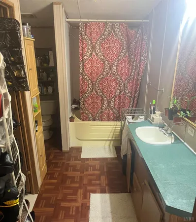 a bathroom with a tub sink and mirror