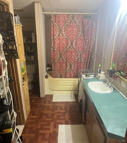a bathroom with a tub sink and mirror