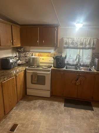 a kitchen with a sink a stove and cabinets