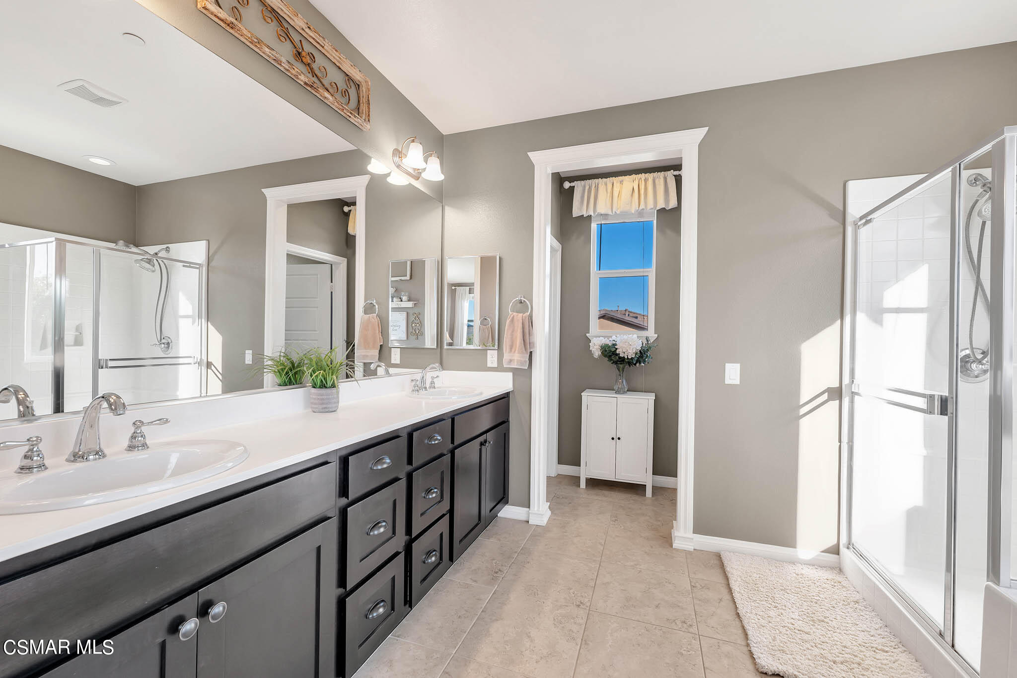 324 River Street Fillmore, CA 93015 - Photo 17 of 48 a spacious bathroom with a double vanity sink a mirror and a shower