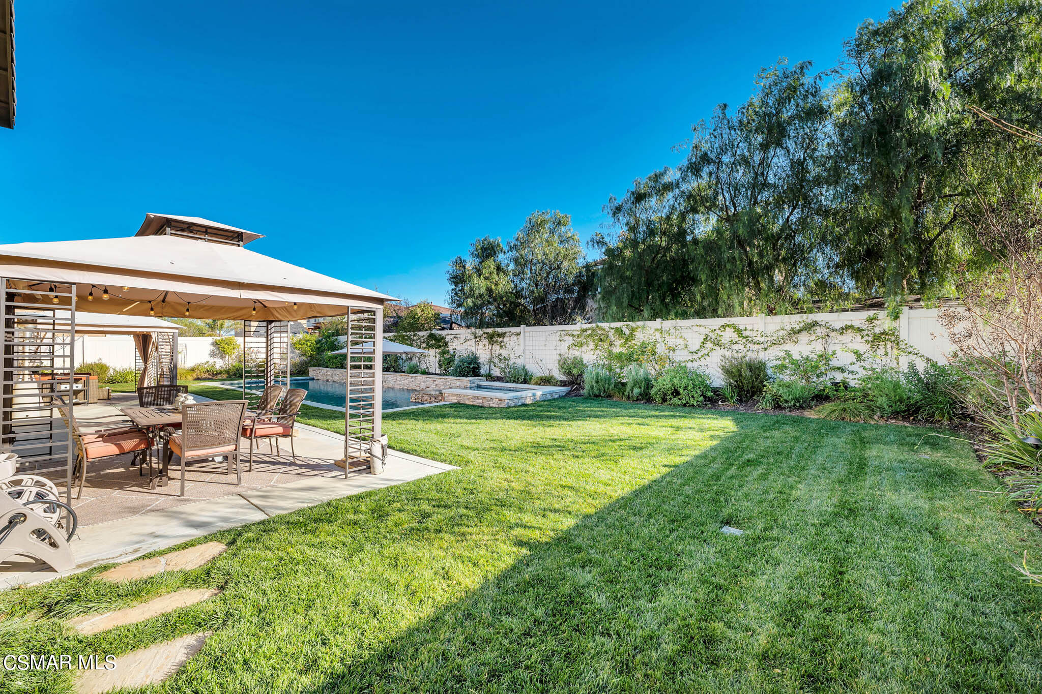 324 River Street Fillmore, CA 93015 - Photo 34 of 48 a view of a patio with table and chairs under an umbrella with large trees