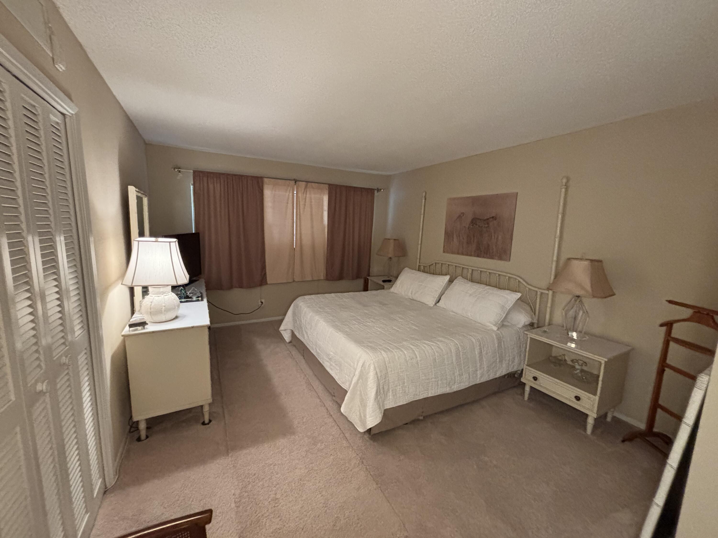 2691 South Course Drive, Unit 408 Pompano Beach, FL 33069 - Photo 12 of 24 a bedroom with a bed and a couch