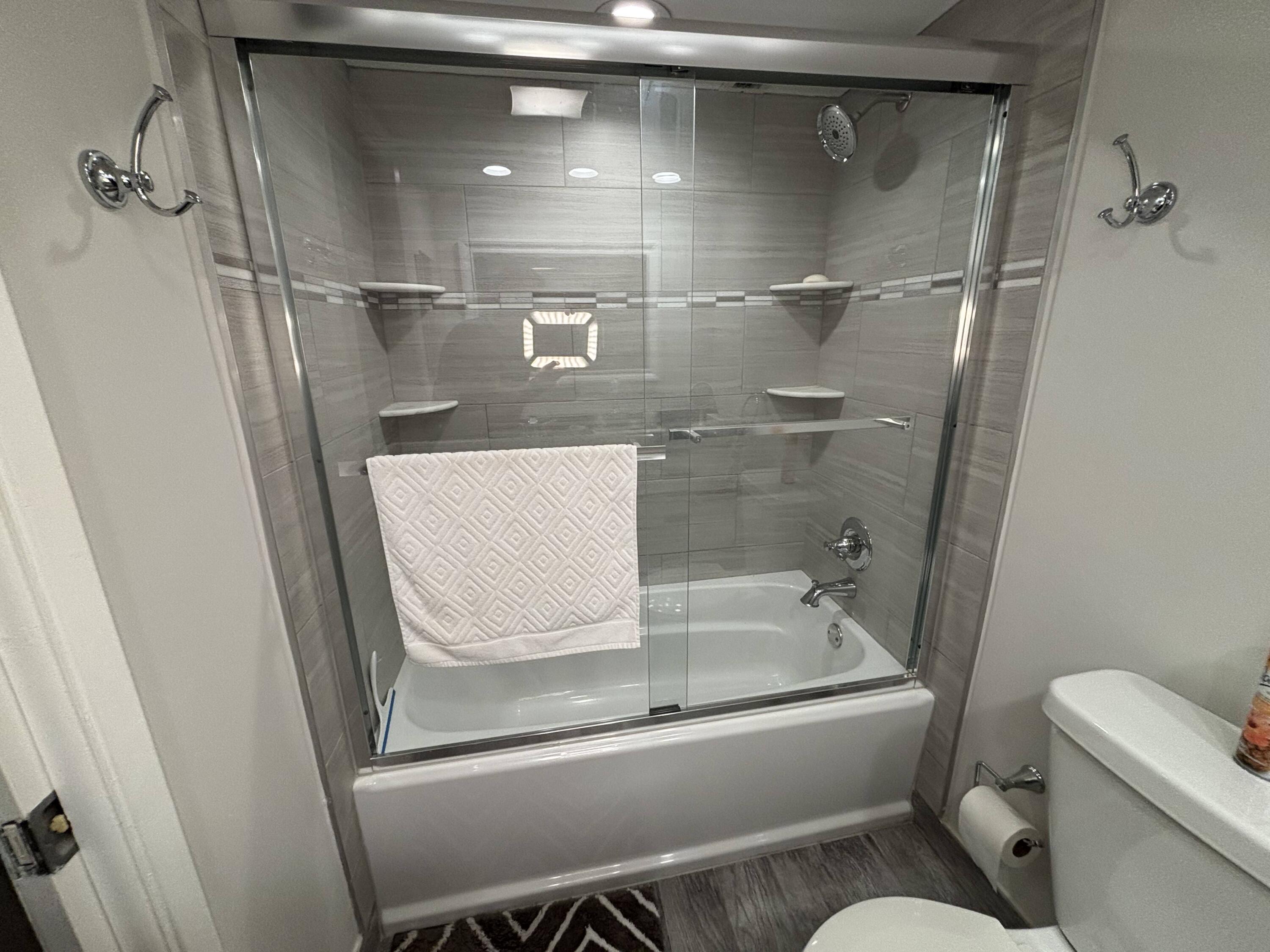 2691 South Course Drive, Unit 408 Pompano Beach, FL 33069 - Photo 13 of 24 a bathroom with a tub and toilet