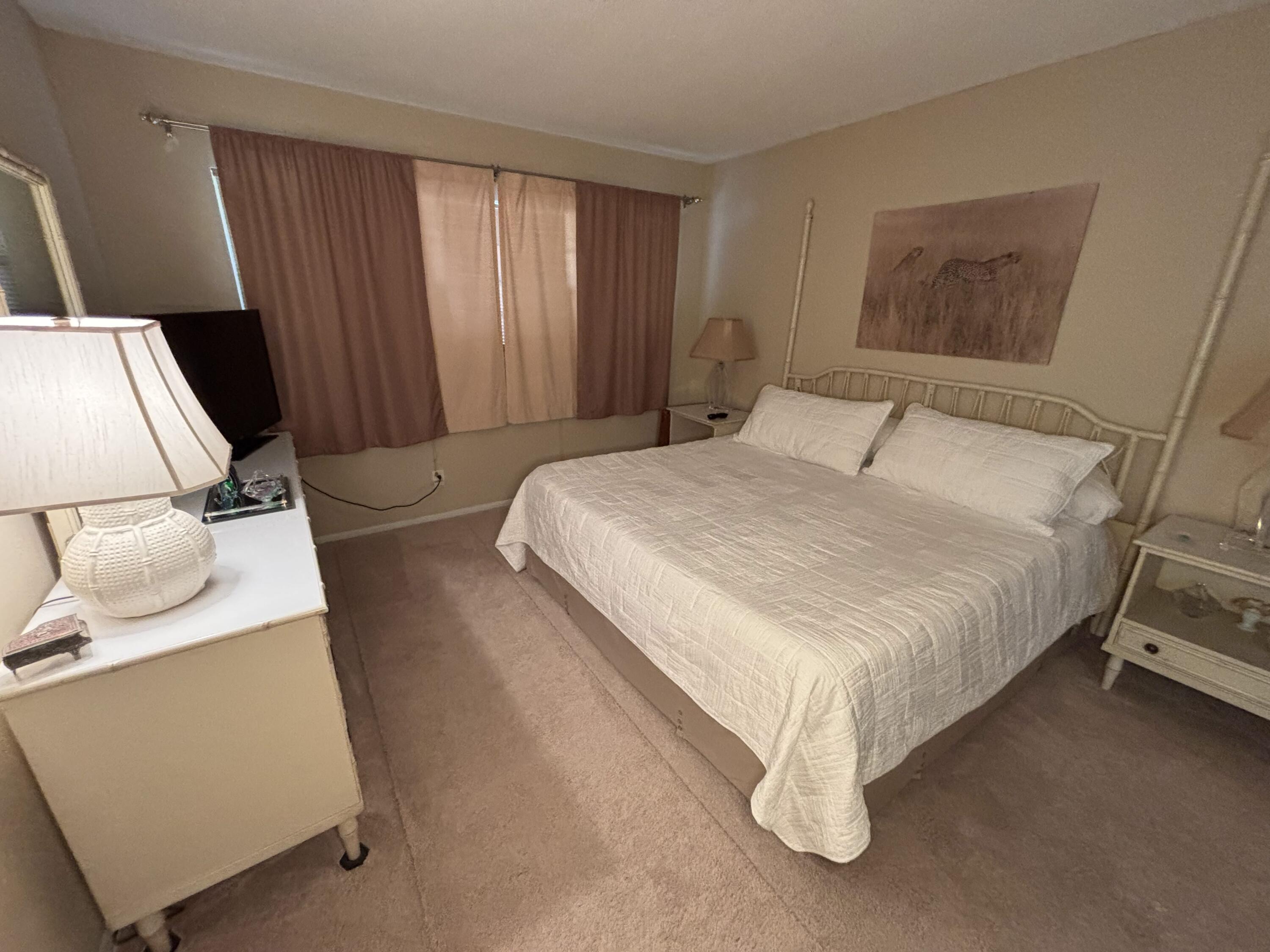 2691 South Course Drive, Unit 408 Pompano Beach, FL 33069 - Photo 16 of 24 a bedroom with a bed and a window