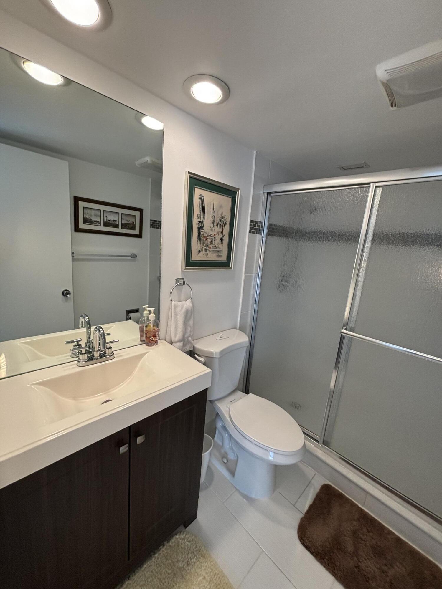 2691 South Course Drive, Unit 408 Pompano Beach, FL 33069 - Photo 17 of 24 a bathroom with a sink a toilet and shower