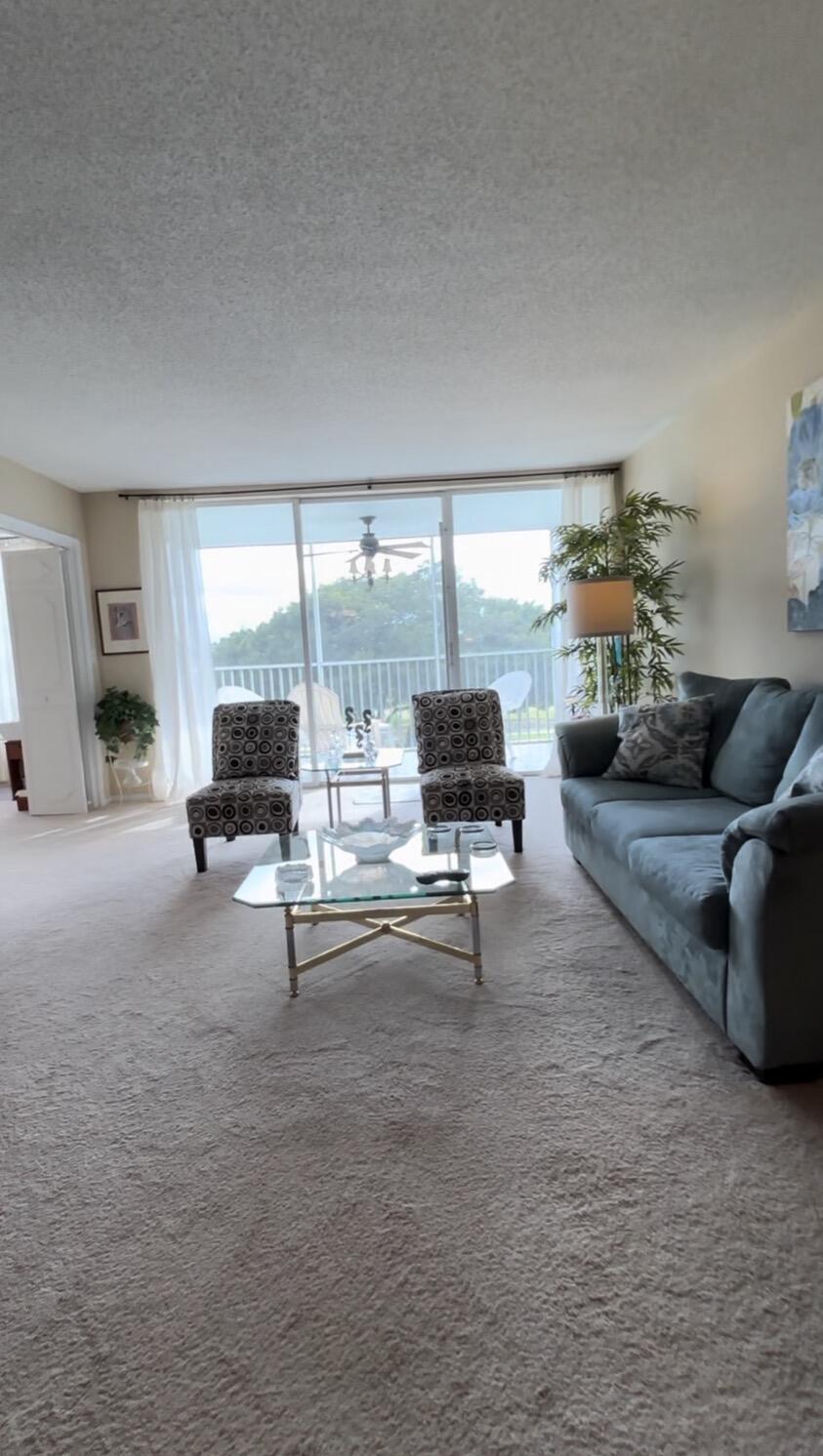 2691 South Course Drive, Unit 408 Pompano Beach, FL 33069 - Photo 4 of 24 a living room with furniture and a large window