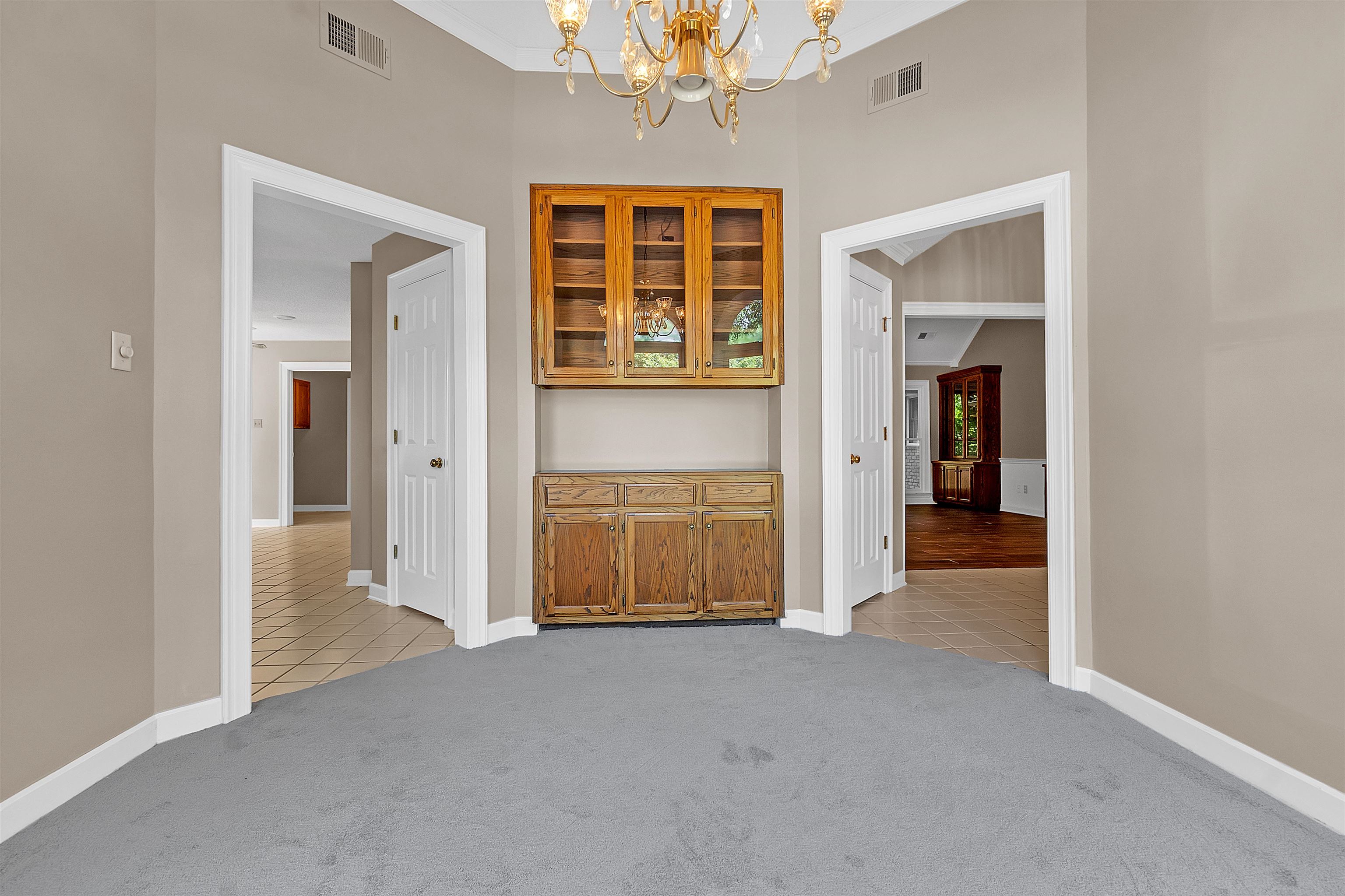 400 Reksten Cove Memphis, TN 38018 - Photo 14 of 26 Built-in wooden cabinetry with glass-front upper cabinets and lower storage