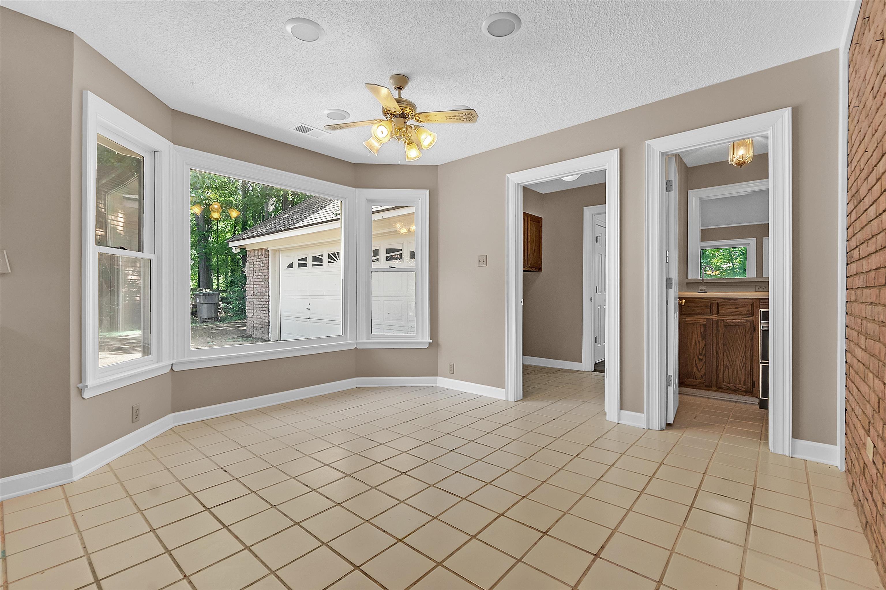 400 Reksten Cove Memphis, TN 38018 - Photo 15 of 26 Bay window with white trim, tan wall paint, and beige tiled flooring