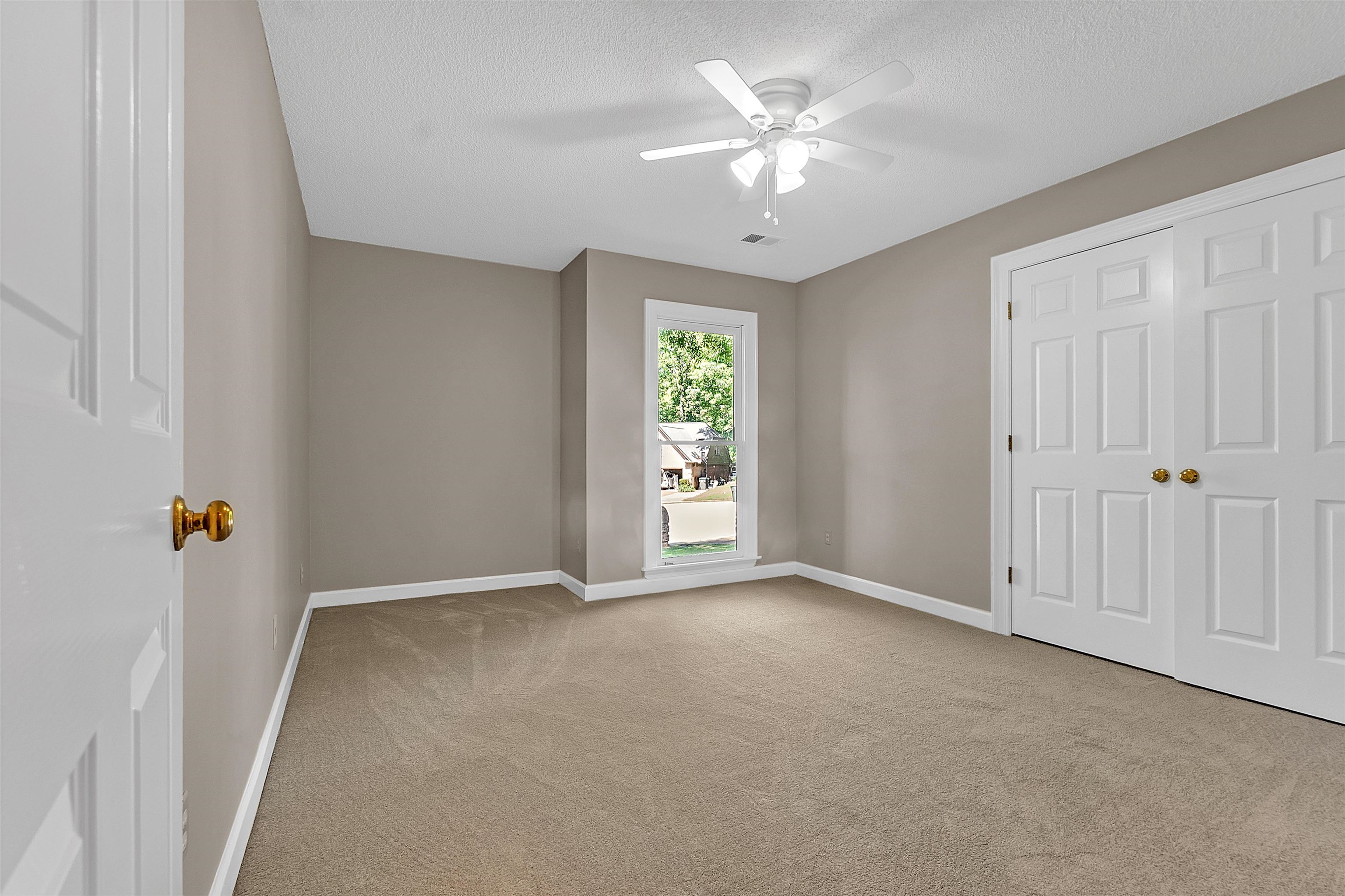 400 Reksten Cove Memphis, TN 38018 - Photo 20 of 26 Carpeted room featuring a single window, a ceiling fan with light fixture, and double bi-fold closet doors