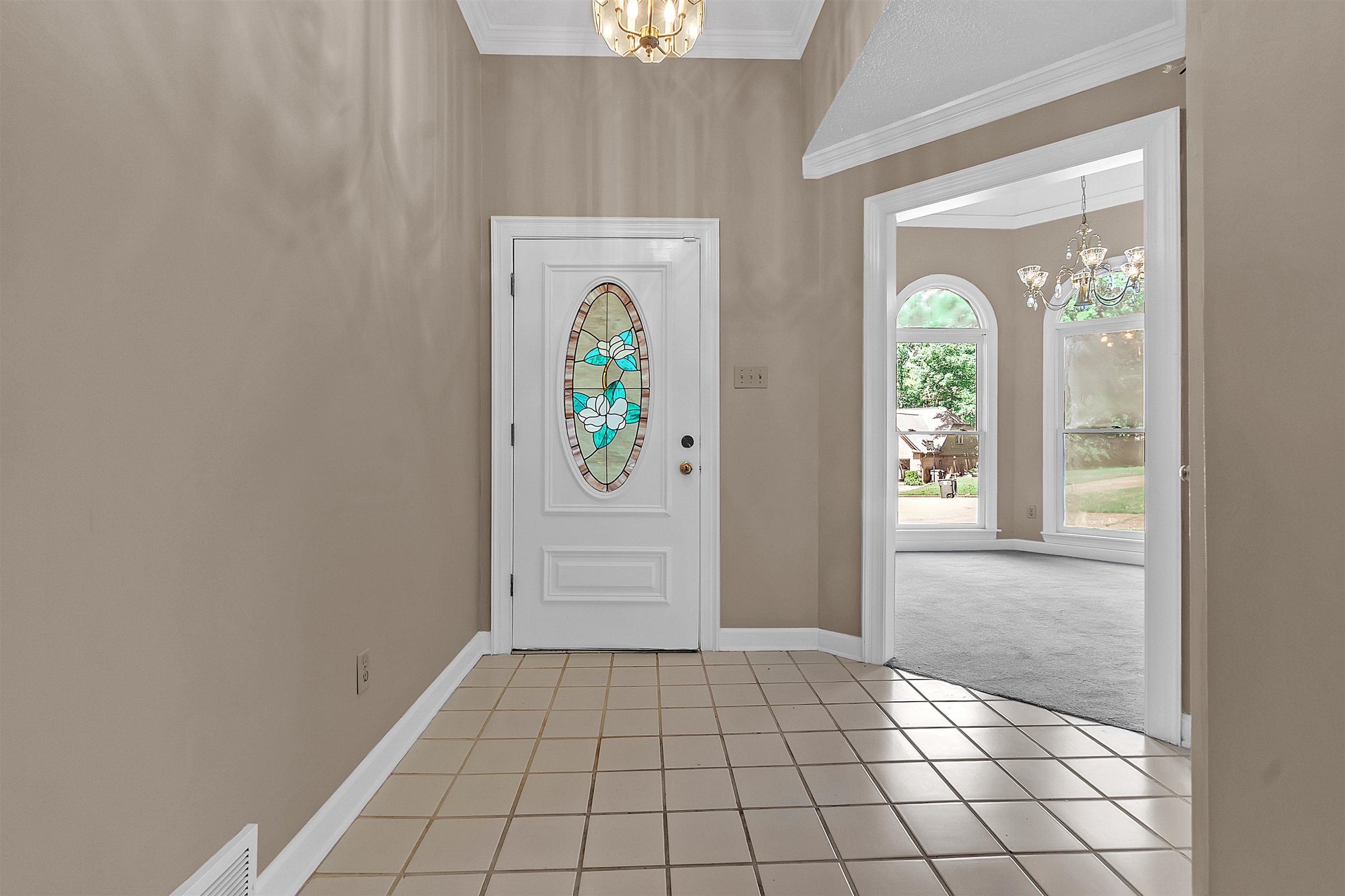 400 Reksten Cove Memphis, TN 38018 - Photo 4 of 26 Entryway featuring ceramic tile flooring, a white front door with stained glass insert, and a traditional overhead light fixture