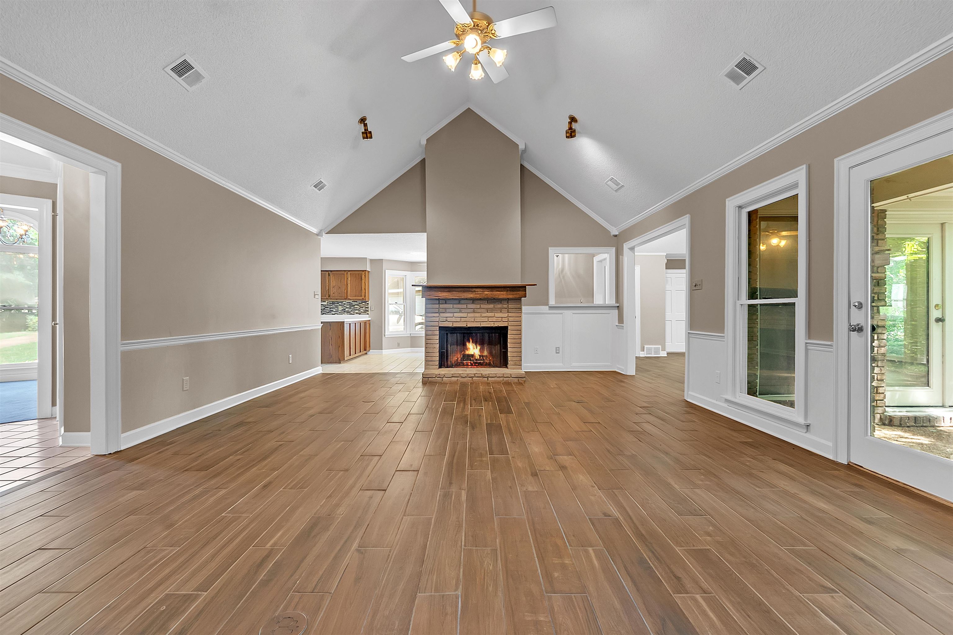 400 Reksten Cove Memphis, TN 38018 - Photo 5 of 26 Vaulted ceilings highlight a brick fireplace with a wood mantel