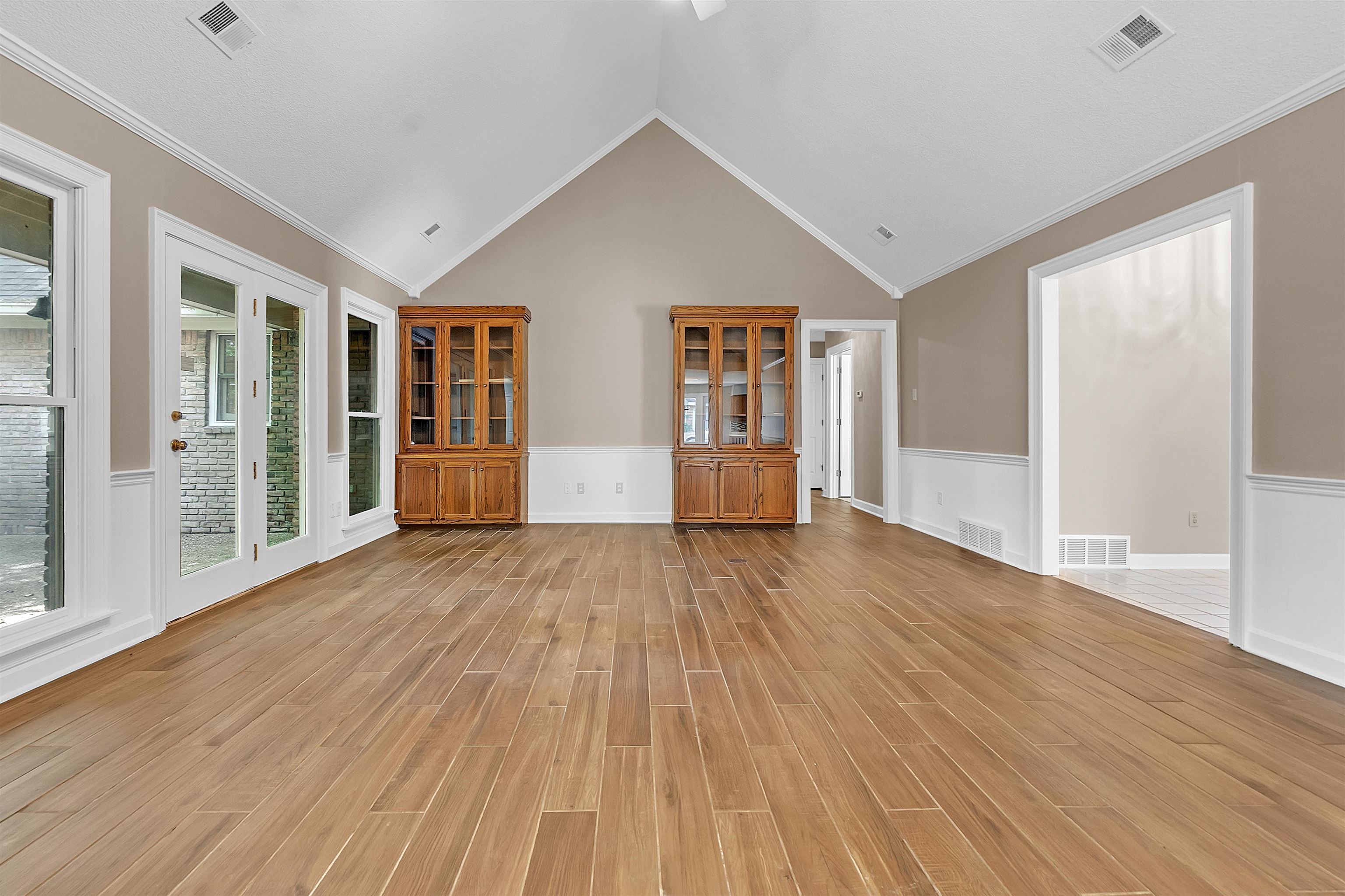 400 Reksten Cove Memphis, TN 38018 - Photo 6 of 26 Spacious interior featuring wood-finish flooring, vaulted ceilings, and a neutral color palette