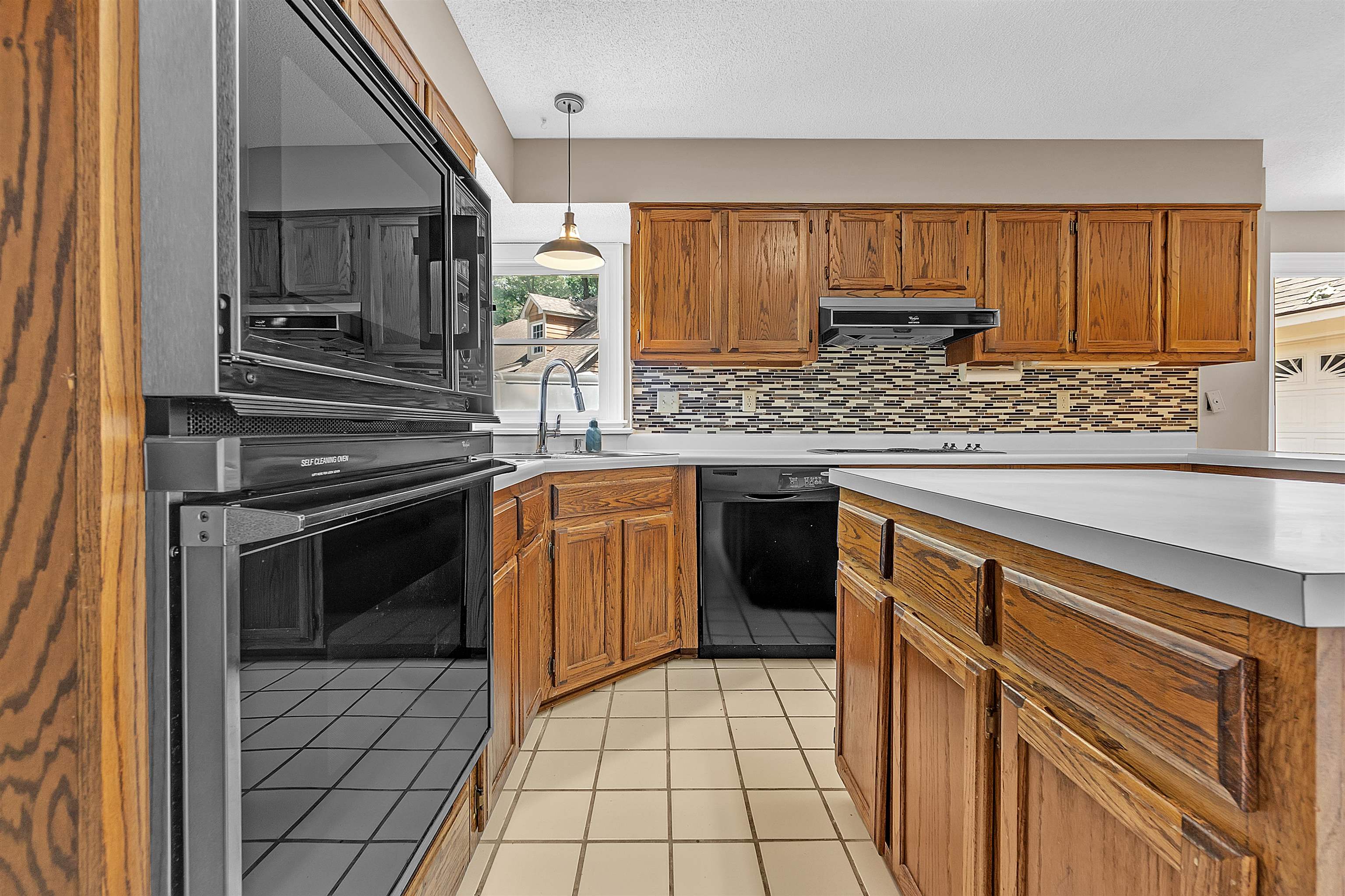 400 Reksten Cove Memphis, TN 38018 - Photo 9 of 26 Kitchen featuring wood cabinetry, white countertops, tile flooring, and a built-in oven with microwave