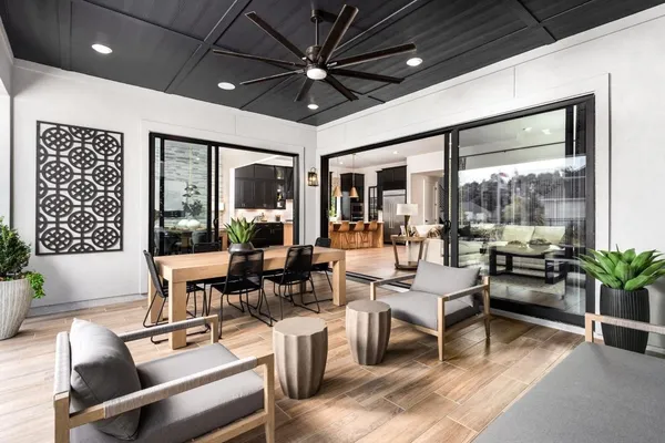 a living room with furniture a chandelier and a large window