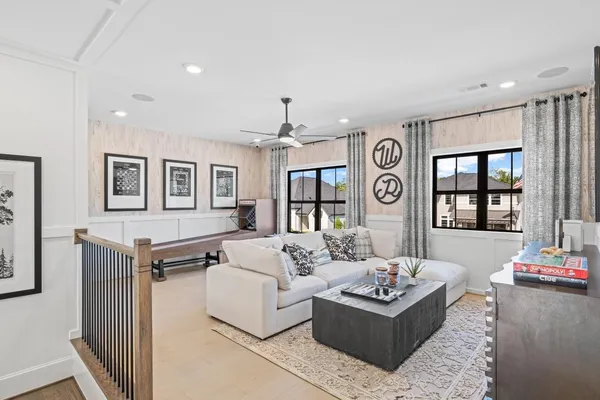 a living room with furniture and wooden floor