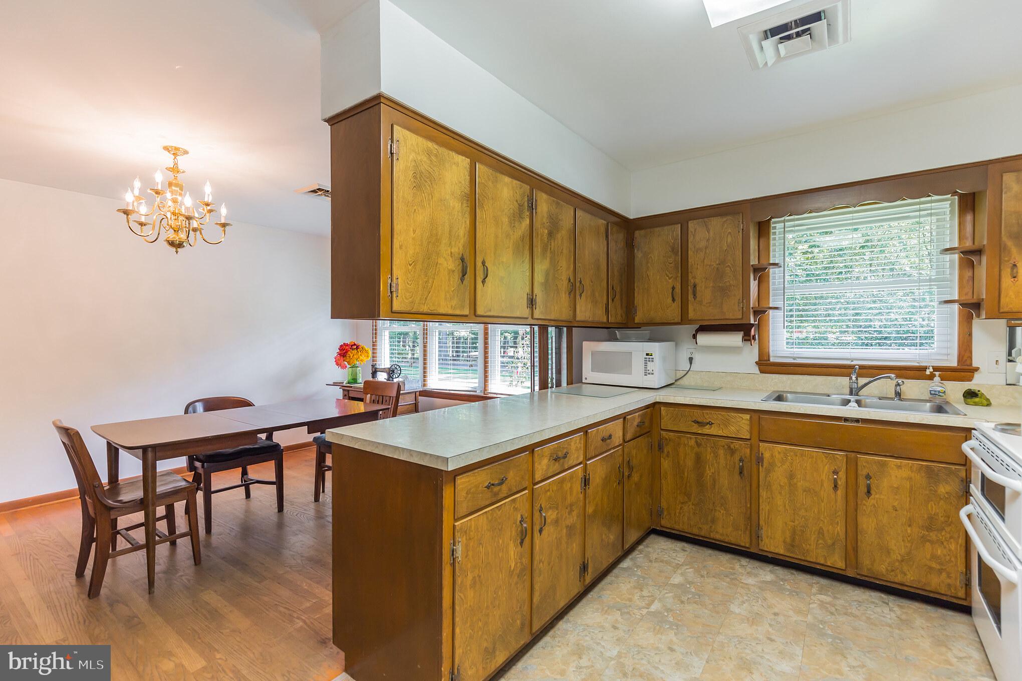 13620 Dowell Road Solomons, MD 20629 - Photo 9 of 28 Tidy kitchen with adjacent dining space, HW floors