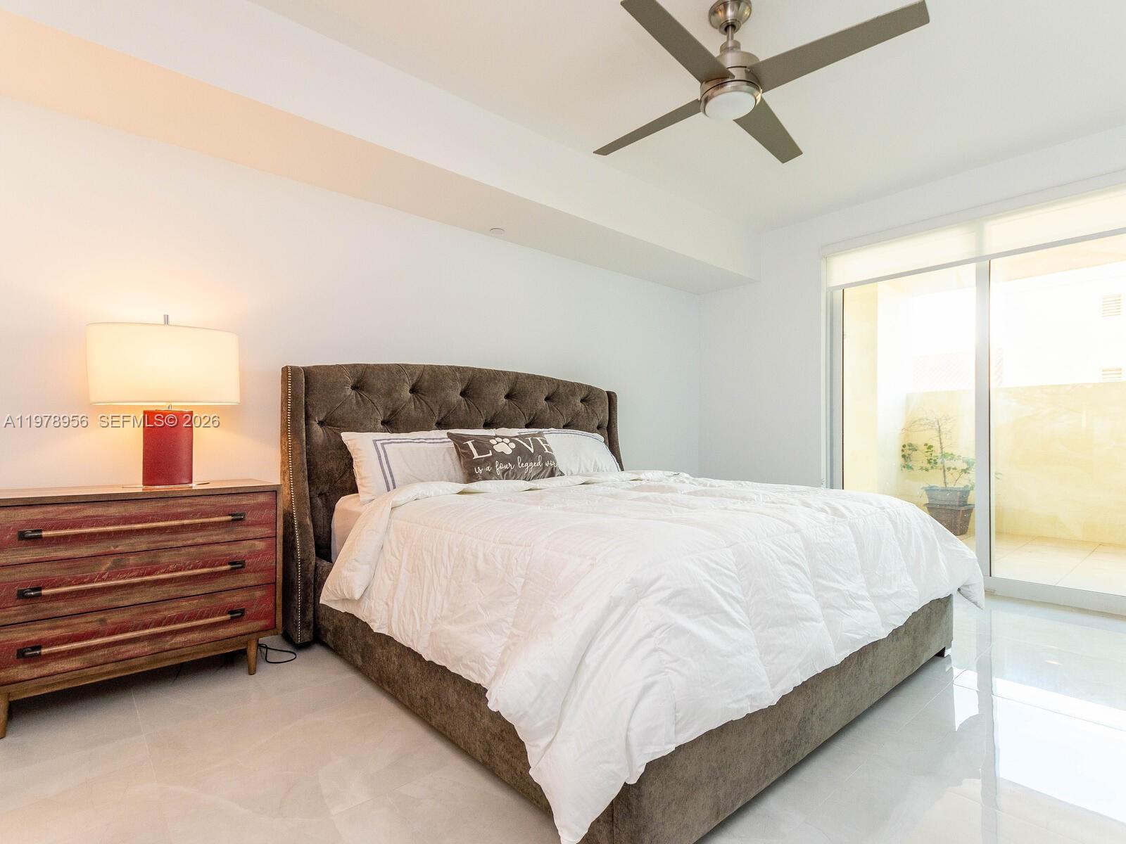 7350 Southwest 89th Street, Unit 719S Miami, FL 33156 - Photo 15 of 30 a large bed sitting in a bedroom next to a window