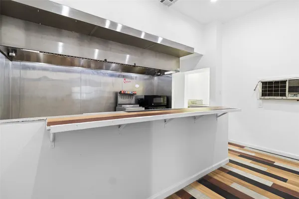 a kitchen with a sink a stove and cabinets