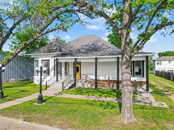 a front view of house with a garden and porch