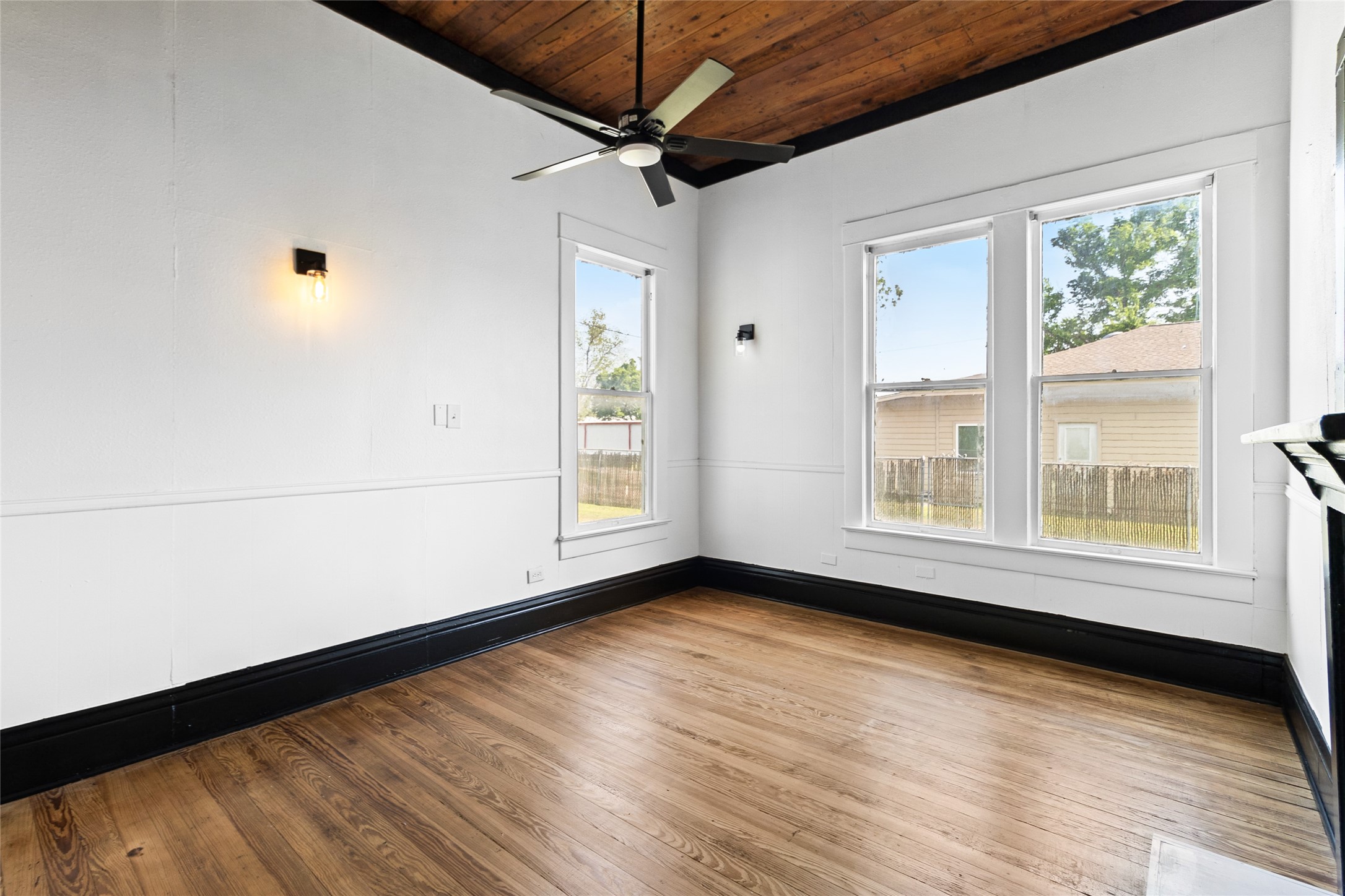 327 South Robb Street Trinity, TX 75862 - Photo 9 of 20 a view of an empty room with a window and wooden floor