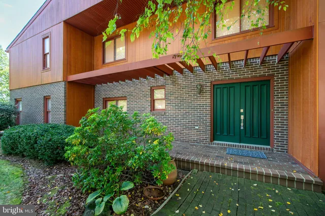 a view of a hallway with wooden cabinet and staircase