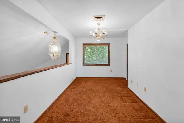 a view of a hallway with a white walls