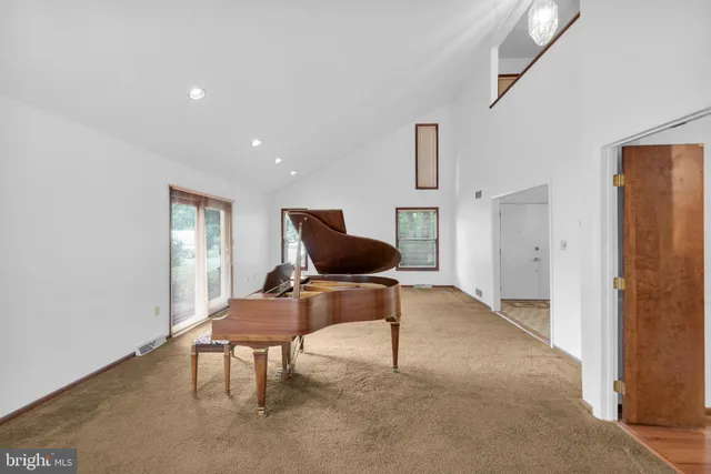 a kitchen with stainless steel appliances granite countertop a refrigerator a sink dishwasher a stove and a wooden floor