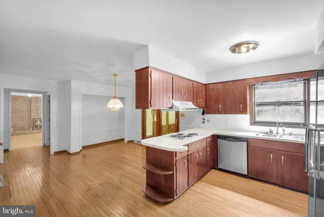 a kitchen with a sink a refrigerator and window
