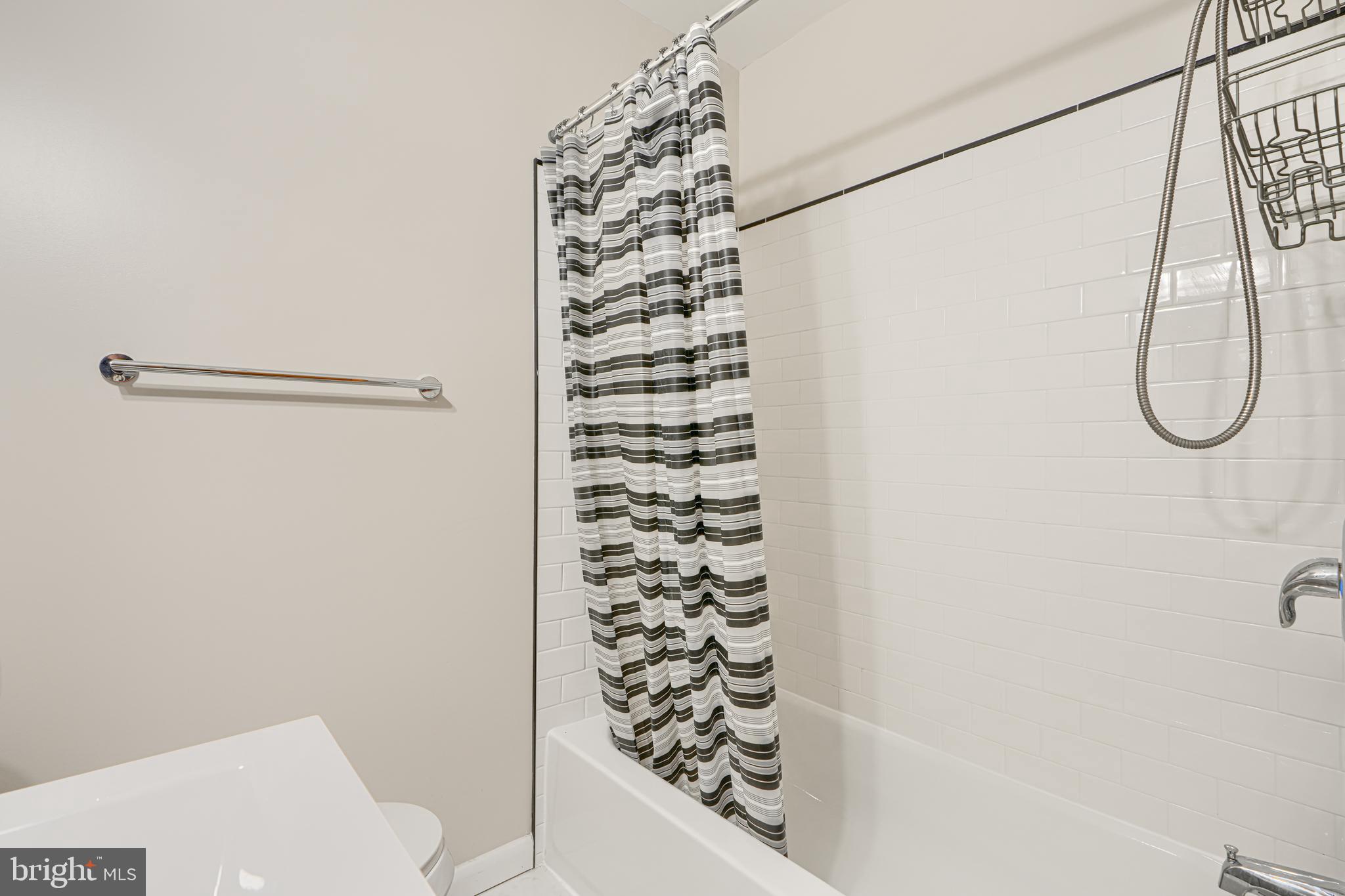 6905 Bank Street Baltimore, MD 21224 - Photo 12 of 17 a bathroom with a shower curtain