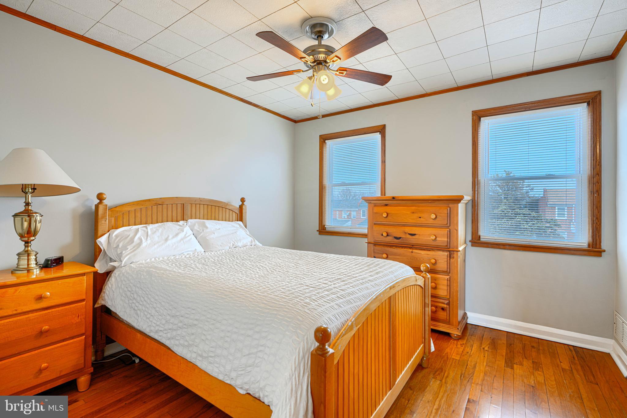 6905 Bank Street Baltimore, MD 21224 - Photo 7 of 17 a bedroom with a bed and wooden floor