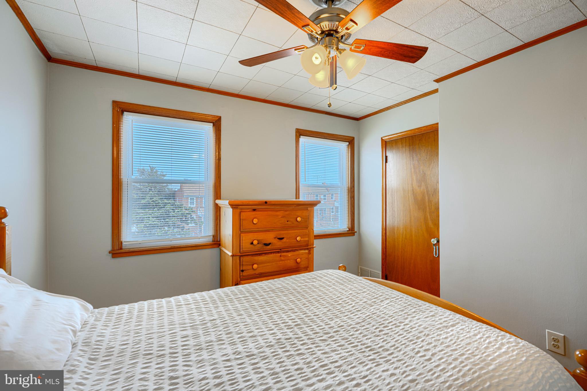 6905 Bank Street Baltimore, MD 21224 - Photo 8 of 17 a bedroom with a bed and a chandelier