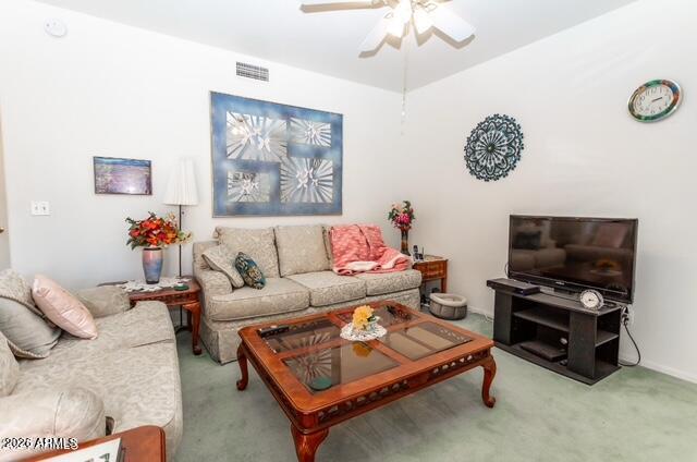 9151 West Greenway Road, Unit 239 Peoria, AZ 85381 - Photo 15 of 18 a living room with furniture a flat screen tv and a wall paintings
