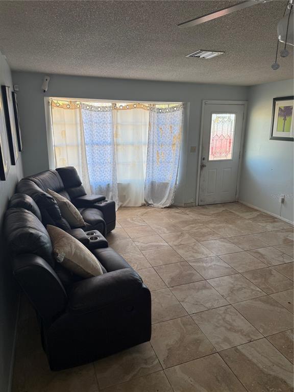 750 Hampton Drive Northeast Palm Bay, FL 32905 - Photo 3 of 8 a living room with furniture and a window