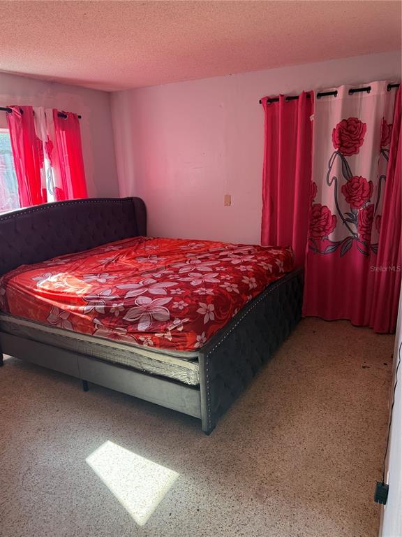 750 Hampton Drive Northeast Palm Bay, FL 32905 - Photo 5 of 8 a bed sitting in a bedroom next to a window