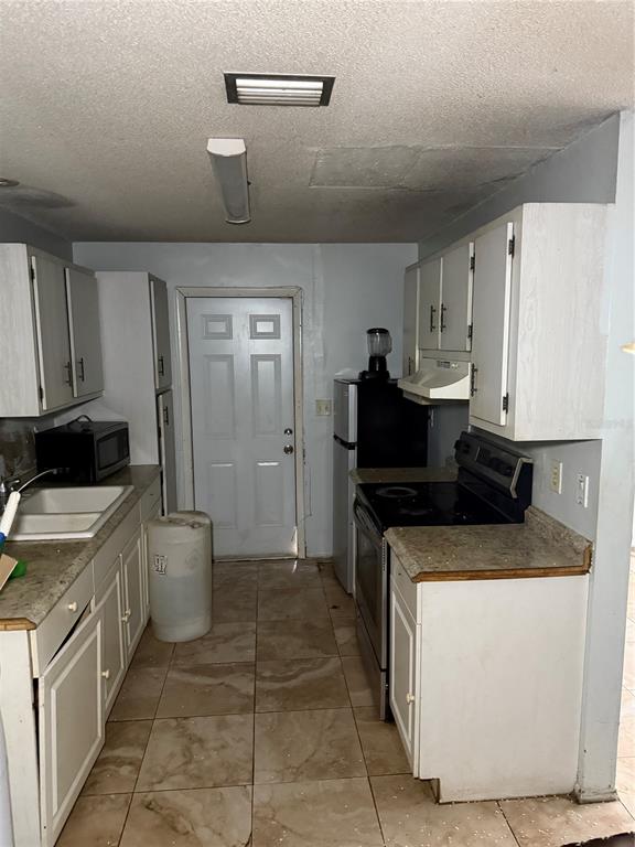 750 Hampton Drive Northeast Palm Bay, FL 32905 - Photo 6 of 8 a kitchen with a stove and a refrigerator