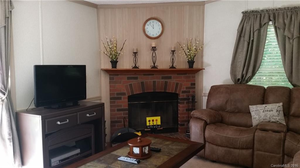 6016 Ra Austin Road Marshville, NC 28103 - Photo 3 of 13 a living room with furniture a fireplace and a flat screen tv