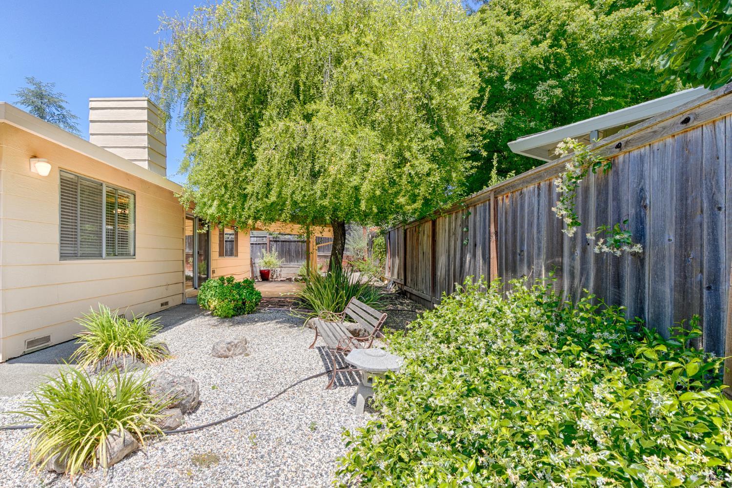 138 Oak Shadow Drive Santa Rosa, CA 95409 - Photo 44 of 50 a backyard of a house with a garden and outdoor seating