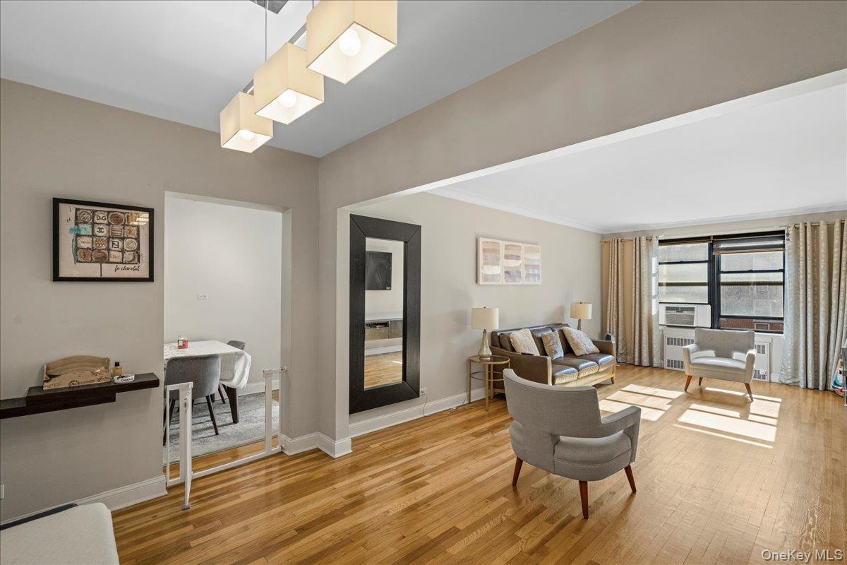 110-45 71st Road, Unit 6D Queens, NY 11375 - Photo 10 of 20 Living room with light wood-type flooring, radiator heating unit, and ornamental molding