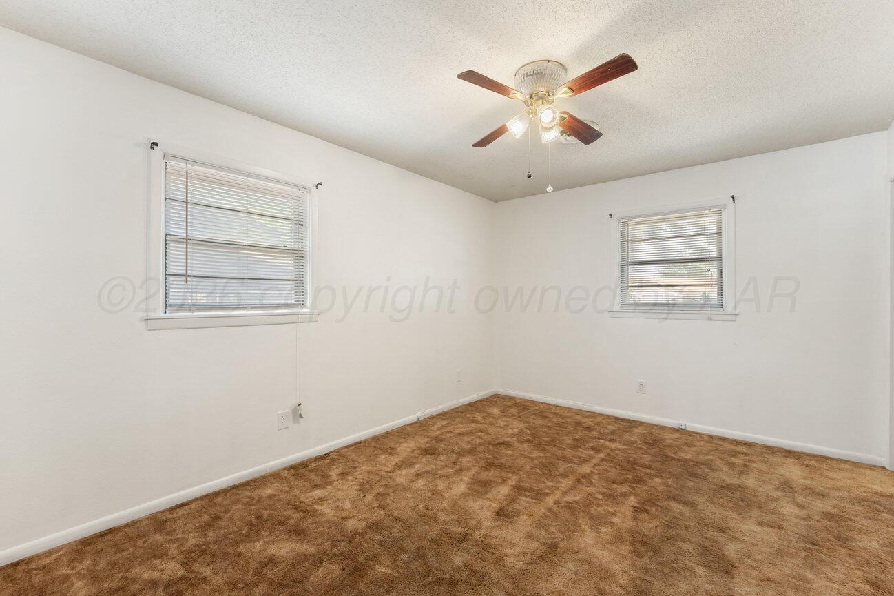 4305 South Bonham Street Amarillo, TX 79110 - Photo 42 of 48 an empty room with closet and ceiling fan