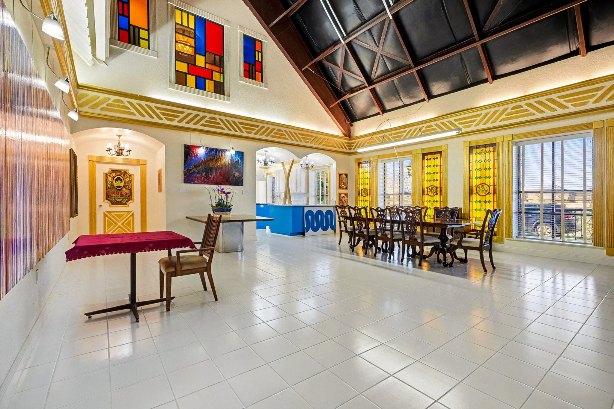 1200 Davenport Parkway Rosharon, TX 77583 - Photo 10 of 49 Grand dining and entertaining space featuring vaulted ceilings, colorful stained-glass
windows, and elegant architectural detailing.