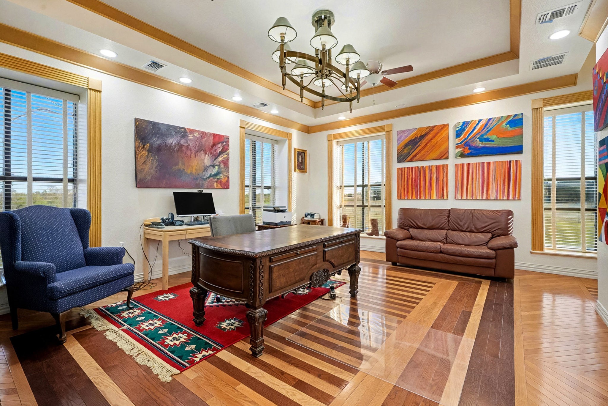 1200 Davenport Parkway Rosharon, TX 77583 - Photo 12 of 49 Sophisticated home office with custom hardwood flooring, large picture windows, and
colorful contemporary art.