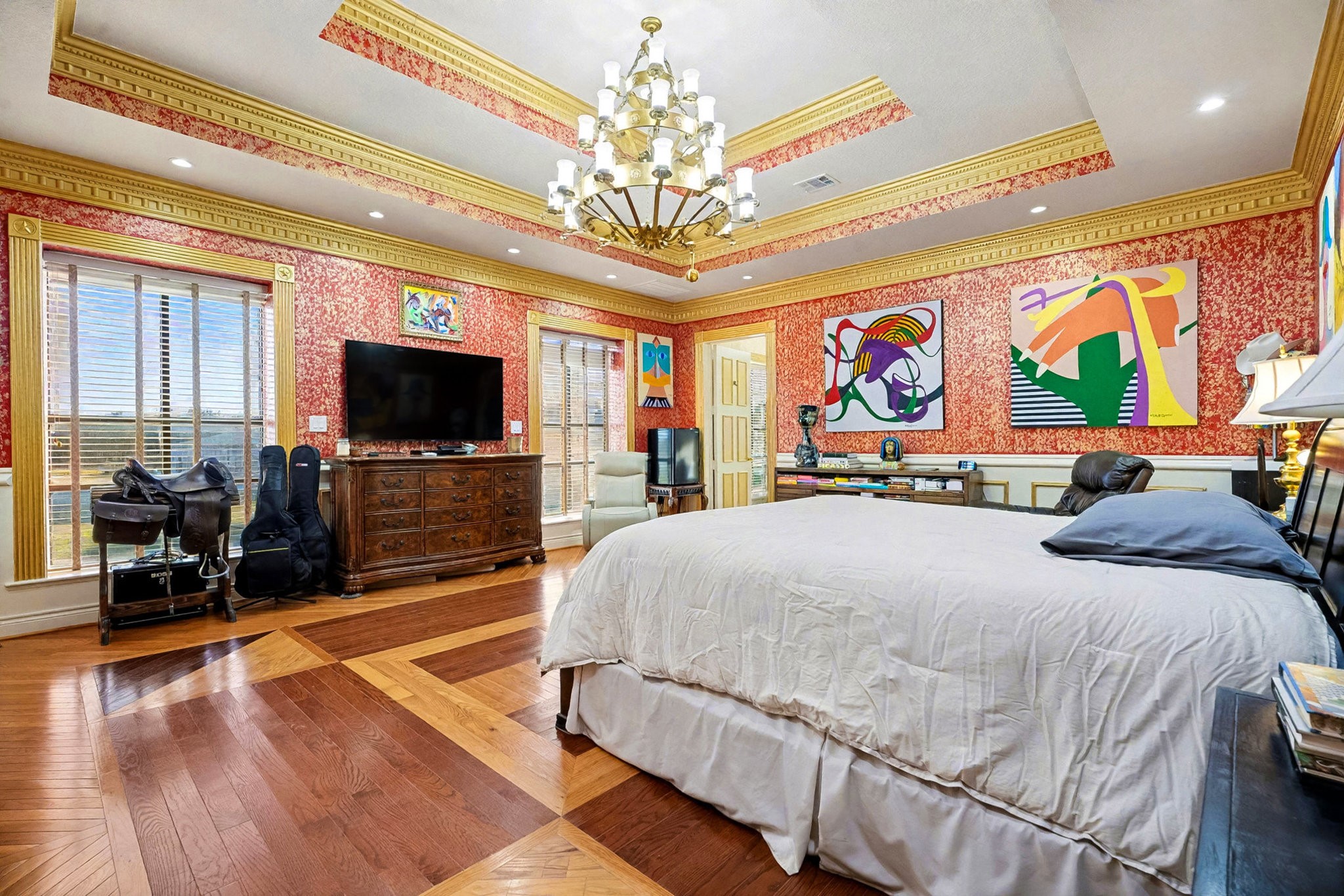 1200 Davenport Parkway Rosharon, TX 77583 - Photo 15 of 49 Luxurious primary bedroom with elegant tray ceiling, gold crown molding, and rich
hardwood flooring accented by modern art.