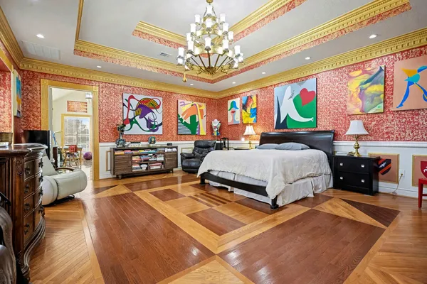 a very nice looking living room with a large window and a dining table with wooden floor