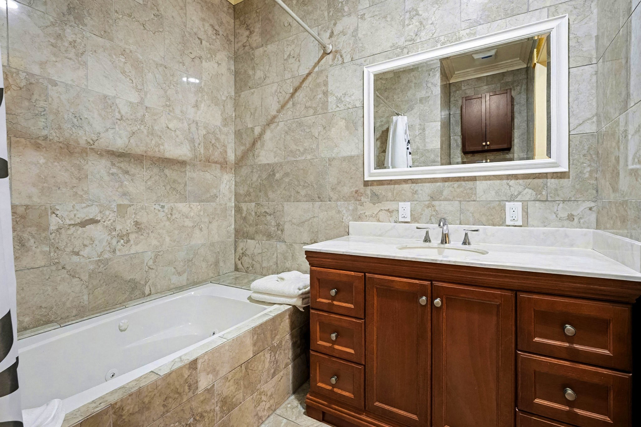 1200 Davenport Parkway Rosharon, TX 77583 - Photo 25 of 49 Guest bathroom (1) wall marble tile surround, soaking tub and shower combo, and rich
wood vanity with marble countertop.