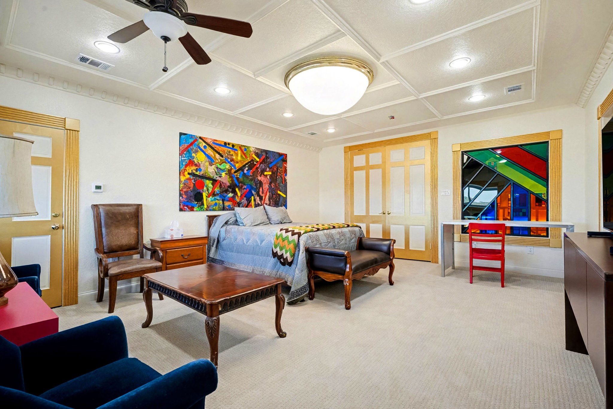 1200 Davenport Parkway Rosharon, TX 77583 - Photo 28 of 49 Second-floor guest room (2) (east end) shown from a different angle, highlighting the colorful
stained-glass window, coffered ceiling, and custom art centerpiece.